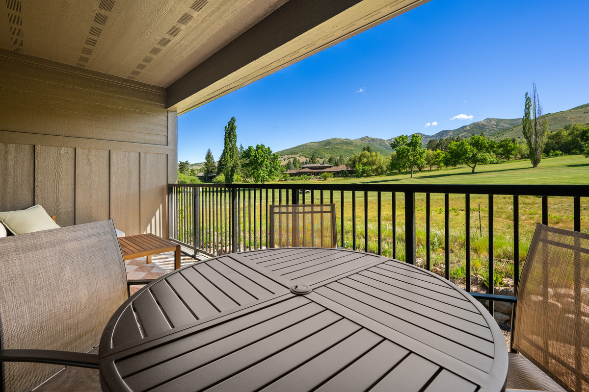 Covered deck with breathtaking golf course and mountain views.