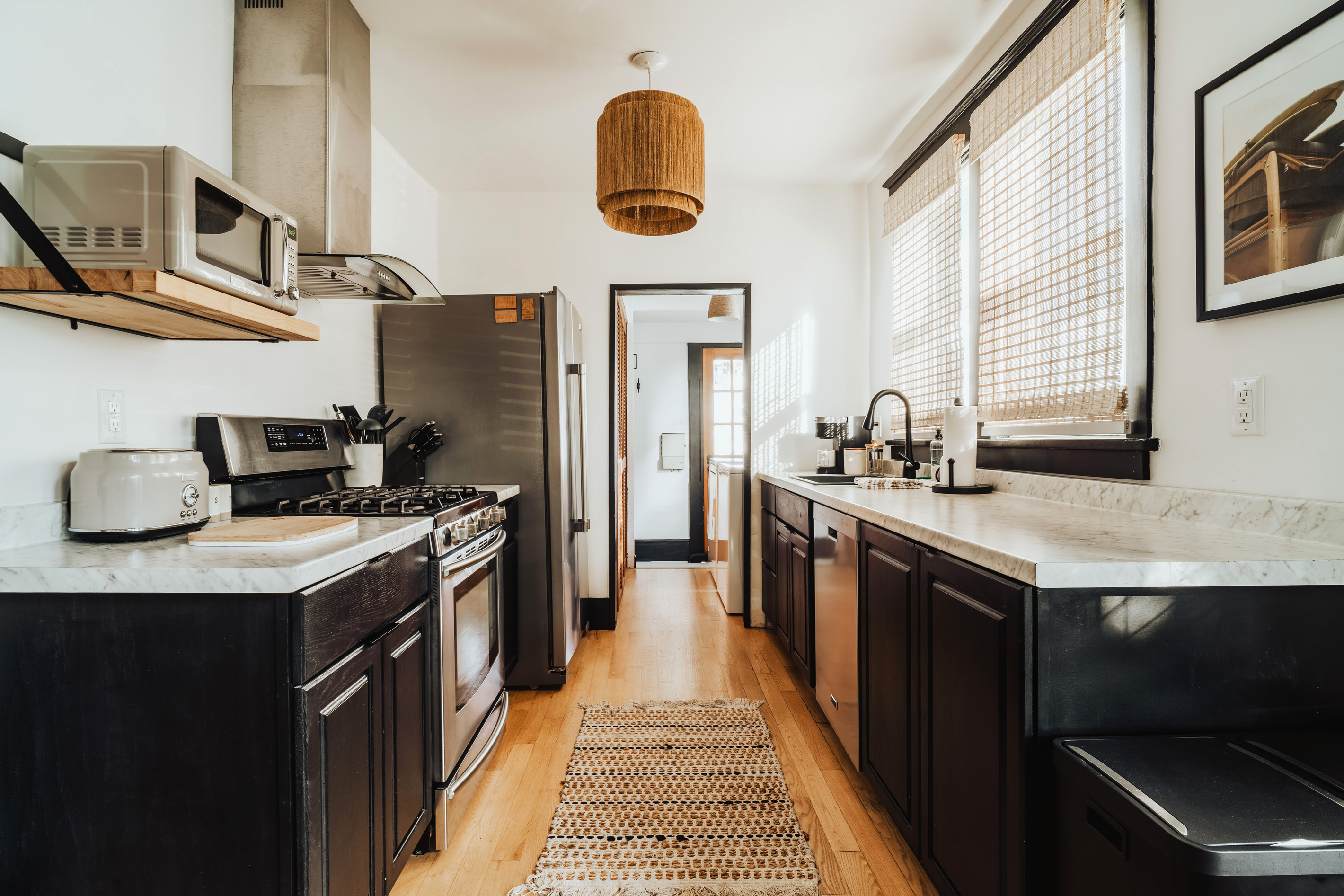 Fully Equipped  Kitchen with Stainless Steel Appliances and Dark Cabinets
