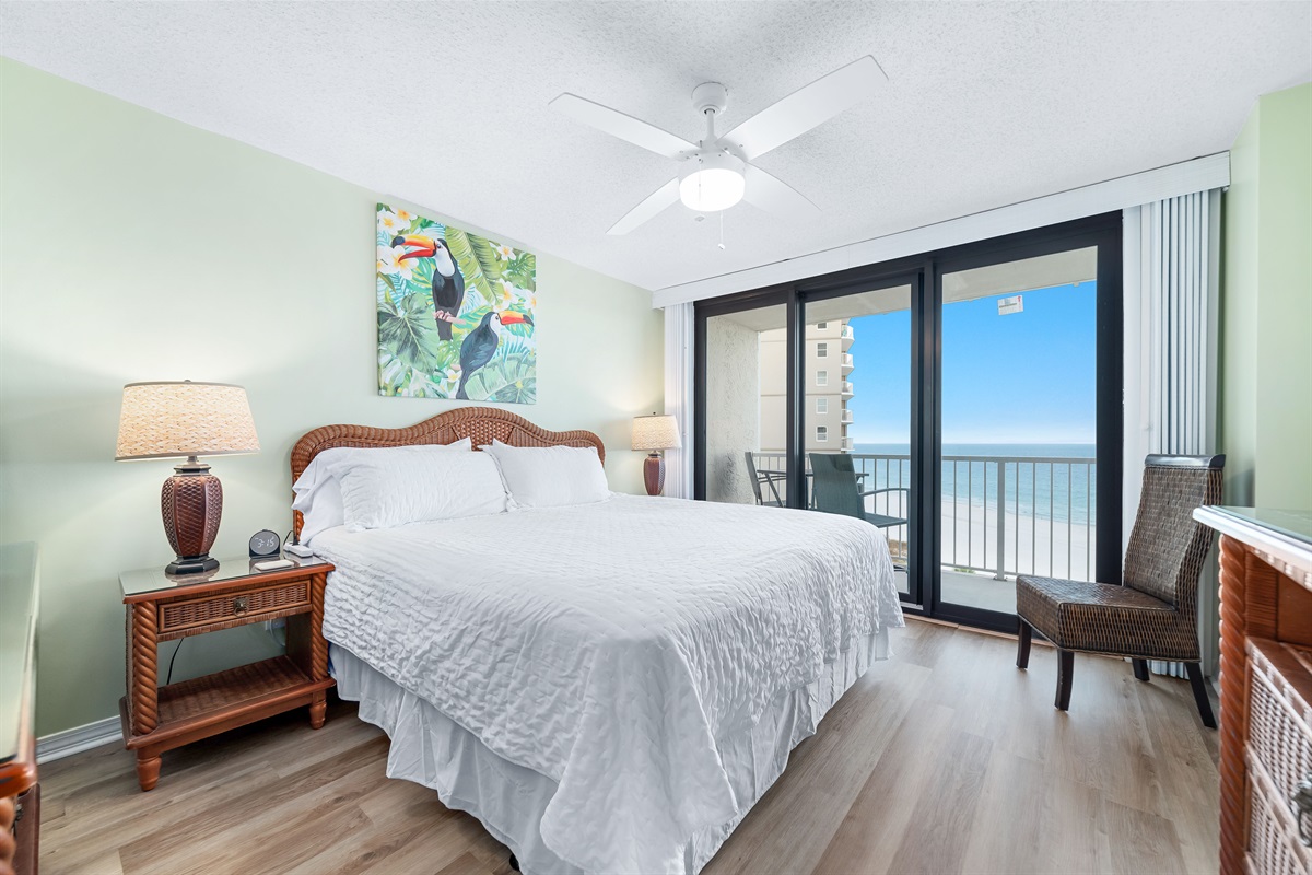 Enjoy the perfect blend of comfort and coastal beauty in this inviting bedroom with direct balcony access and stunning ocean views.