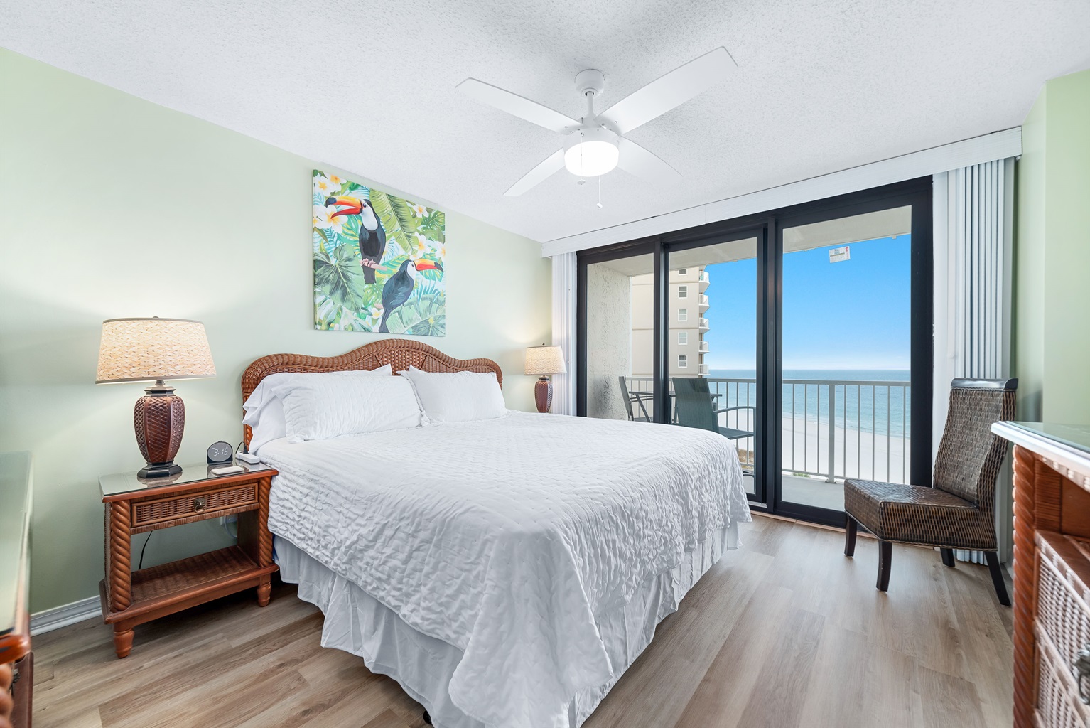 Enjoy the perfect blend of comfort and coastal beauty in this inviting bedroom with direct balcony access and stunning ocean views.