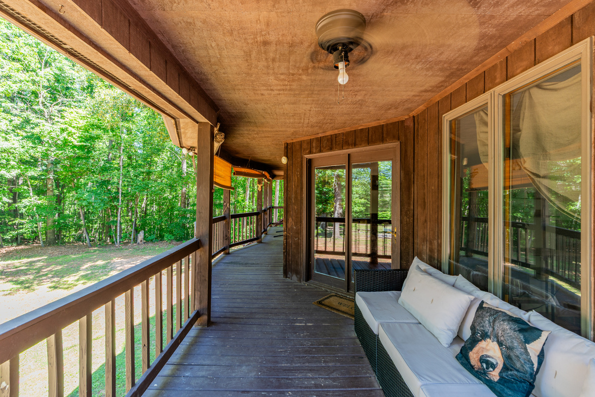 Spacious Porch: Relax on the wraparound porch surrounded by lush greenery and fresh air!