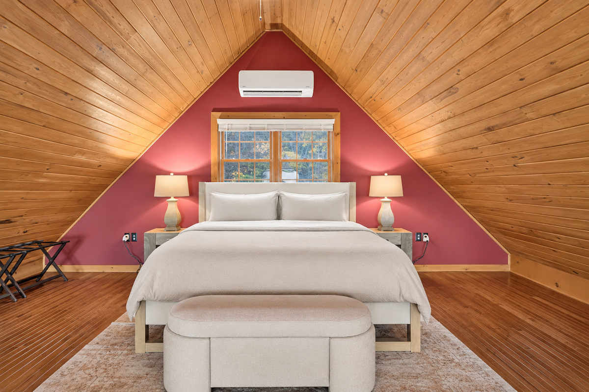 Loft bedroom with vaulted wooden ceiling