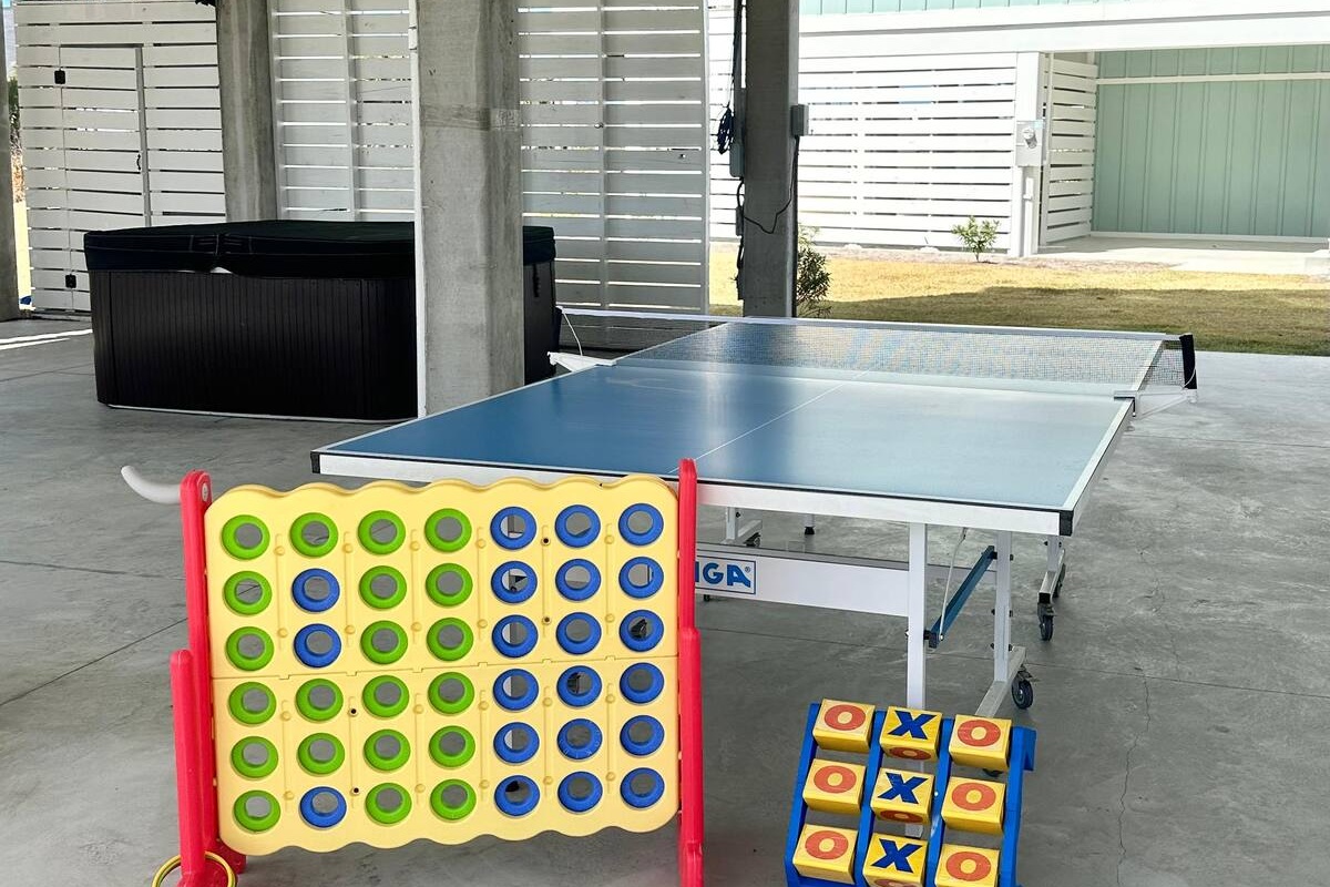 A beach wagon, ping-pong table, and a variety of lawn games are provided to keep the fun going from the sand to the backyard.