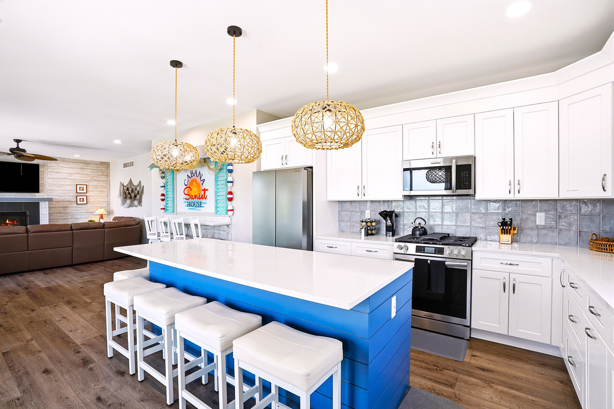This spacious, fully stocked kitchen is equipped with modern appliances, generous counter space, and seating for the whole group to cook and dine together.