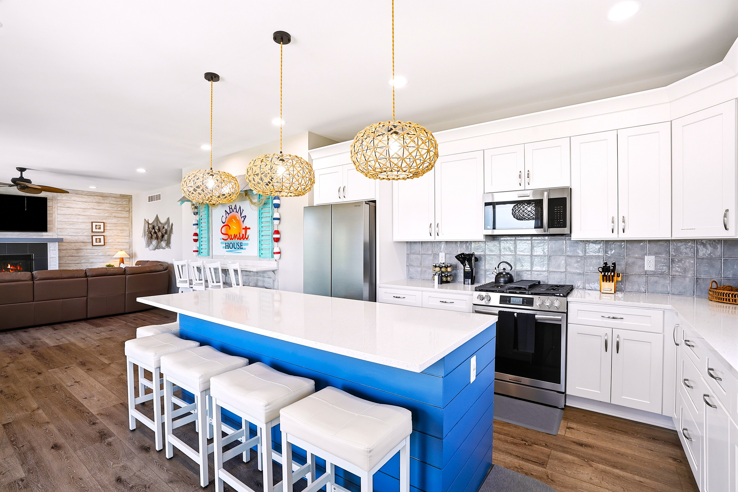 This spacious, fully stocked kitchen is equipped with modern appliances, generous counter space, and seating for the whole group to cook and dine together.