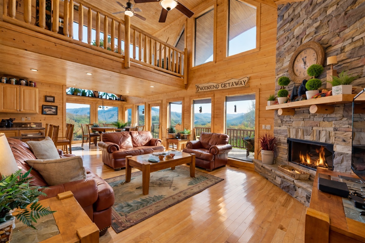 Gather in the heart of the cabin, where floor-to-ceiling windows frame the mountains like a masterpiece and the fireplace glows with stories waiting to be told.