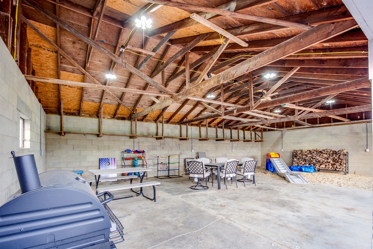 The game barn is a great place for outdoor meals and games!  It is enclosed on 3 sides and wired with lights and fans.