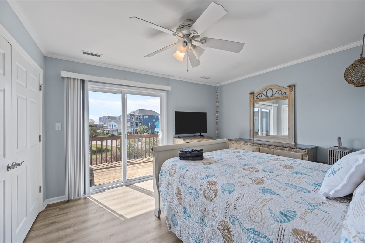 Master bedroom with queen bed and private deck access