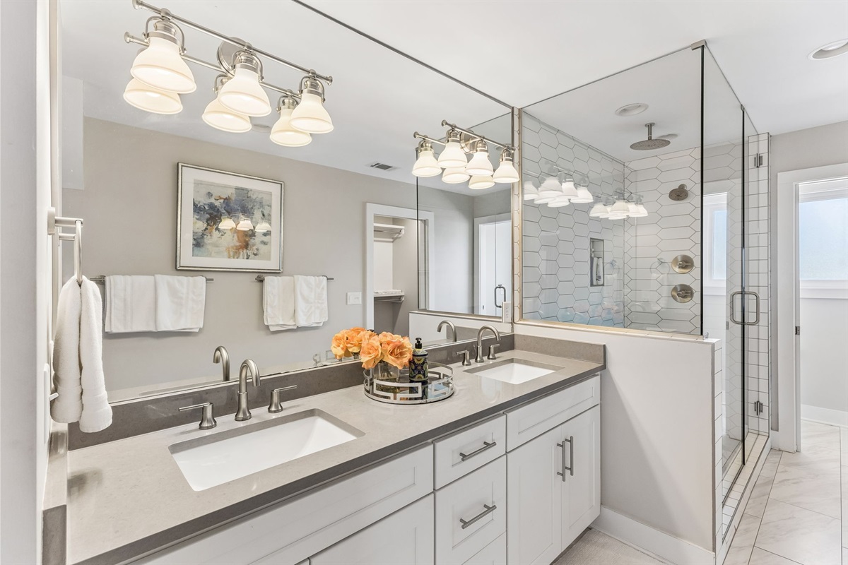 Share the master ensuite without the wait &mdash; double vanity, quartz counters, and enough mirror space so no one's elbowing anyone out of the way.