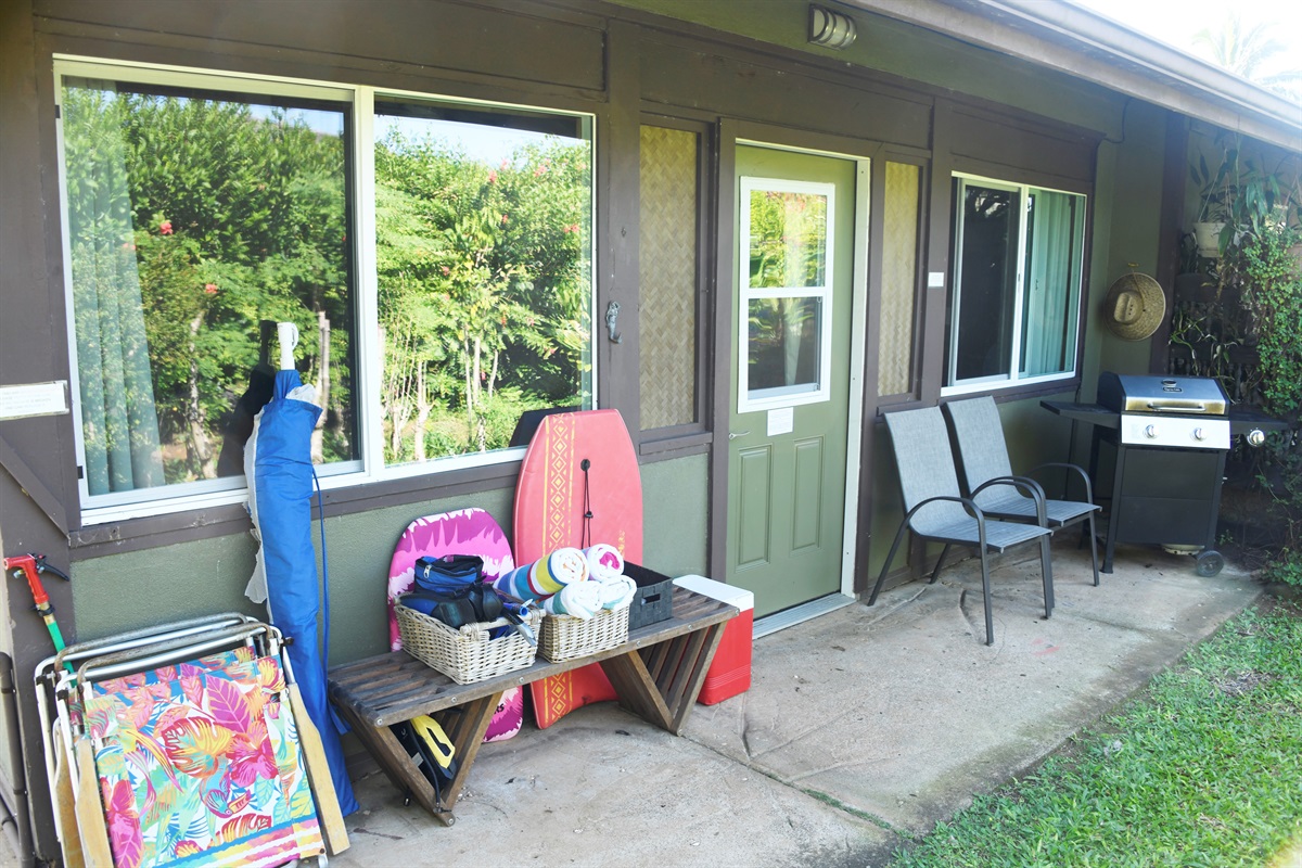 Another view of front door w/beach equipment and gas grill