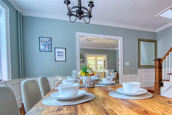 dining table, with dinnerware, wine glass enough to host 10