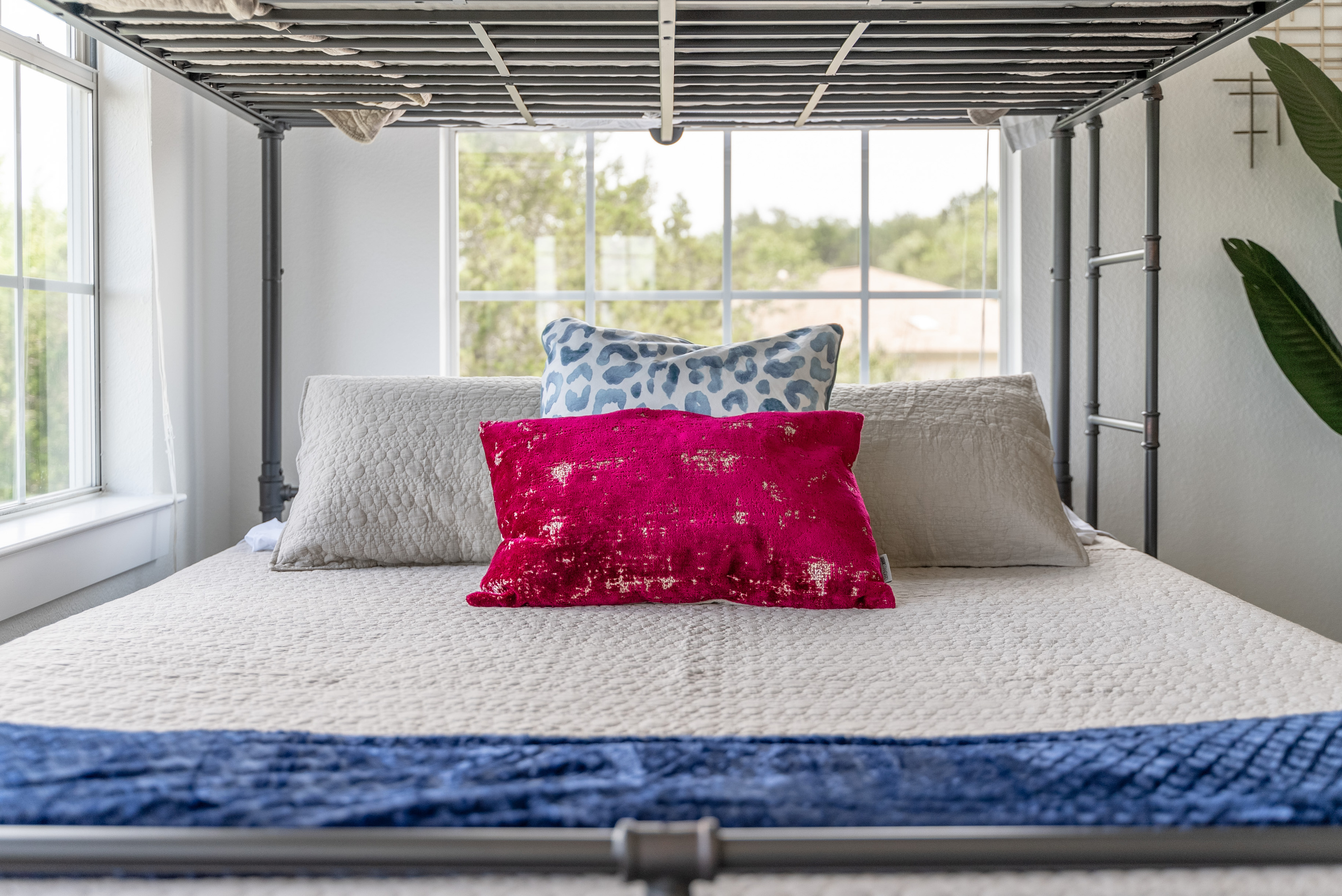 Crisp white linens paired with a bold red accent pillow.