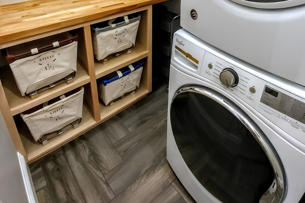 The lower level of the farm house features a laundry folding area and drying rack