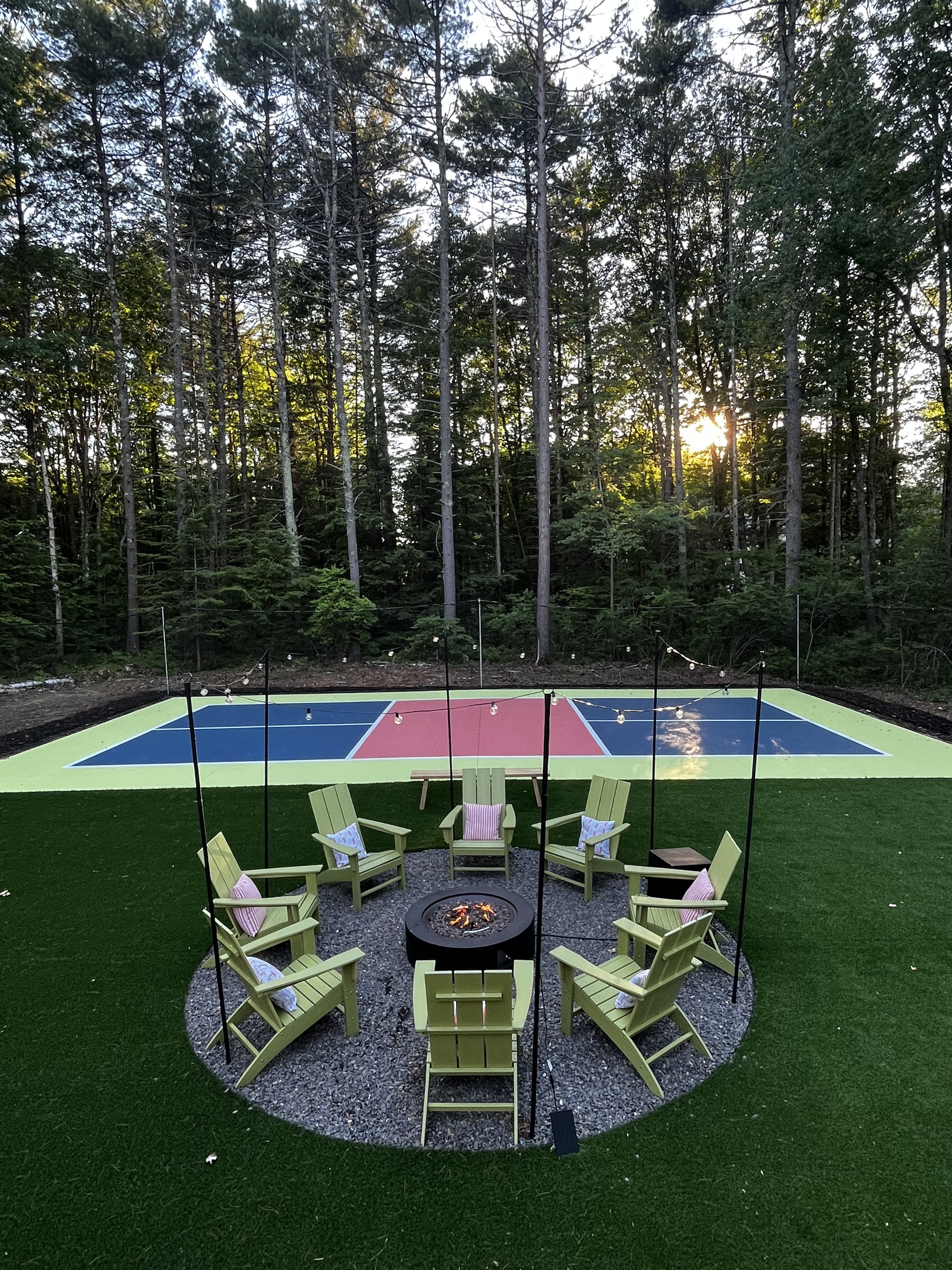 An inviting outdoor firepit surrounded by seating, creating the perfect spot to gather, enjoy drinks, and share stories as the evening winds down.