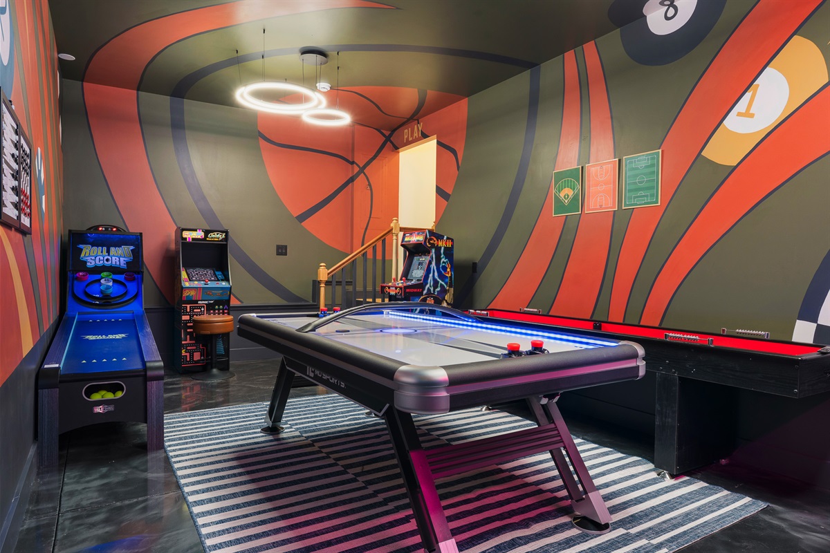 Full game room with pool table and arcade - one of several indoor entertainment spaces