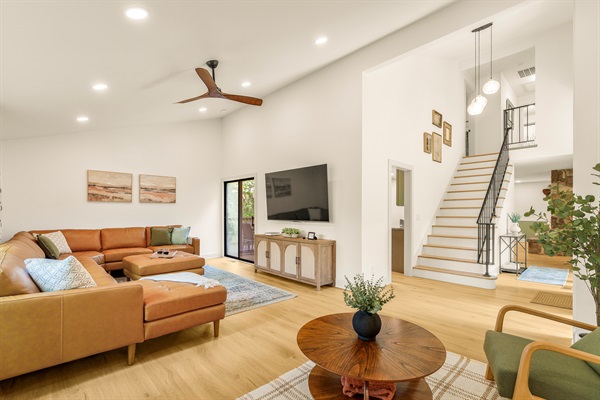 Beautiful and spacious living room is seamlessly connected across the main level and comfortable for the whole group on movie night!