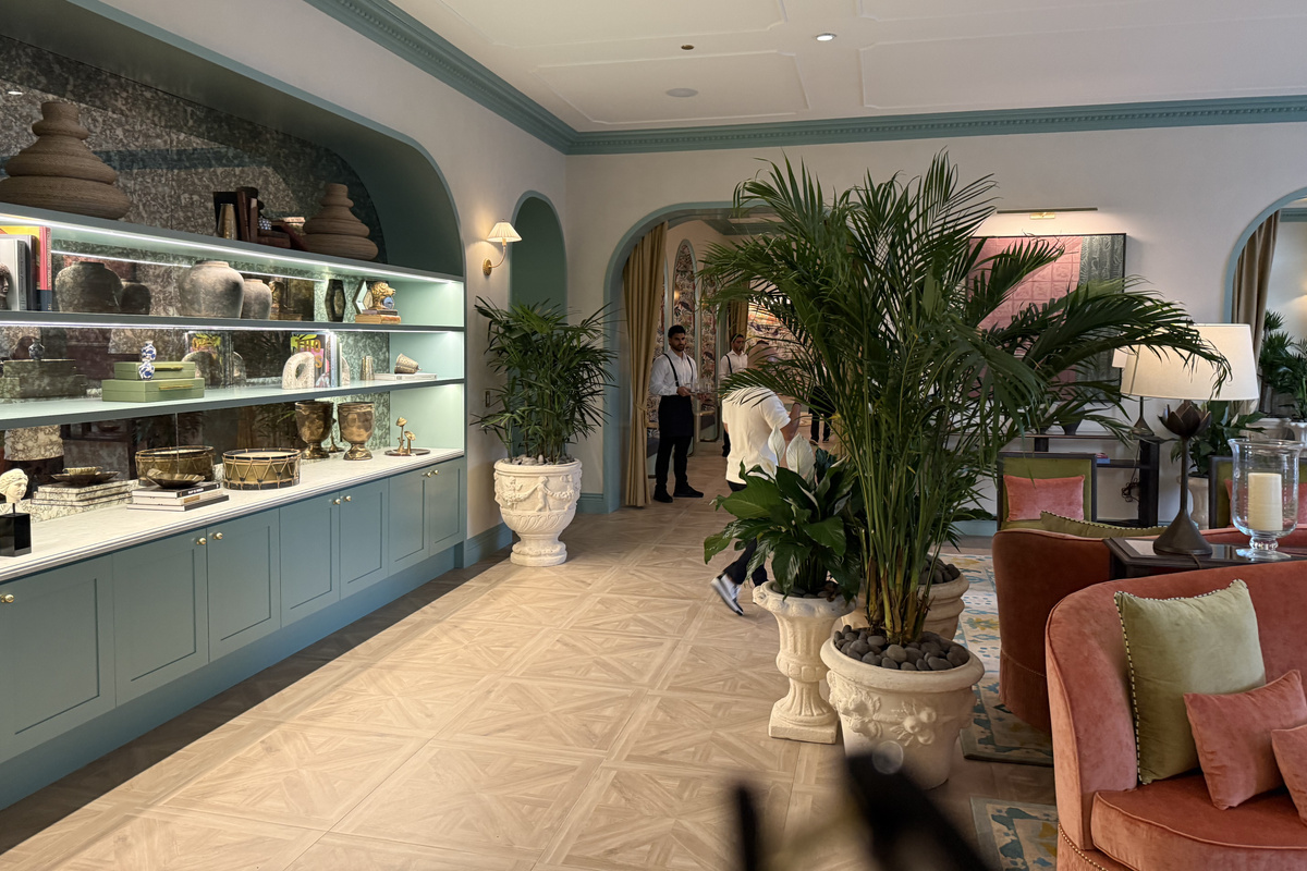 Garden-lined gallery corridor - lush greenery and curated displays.