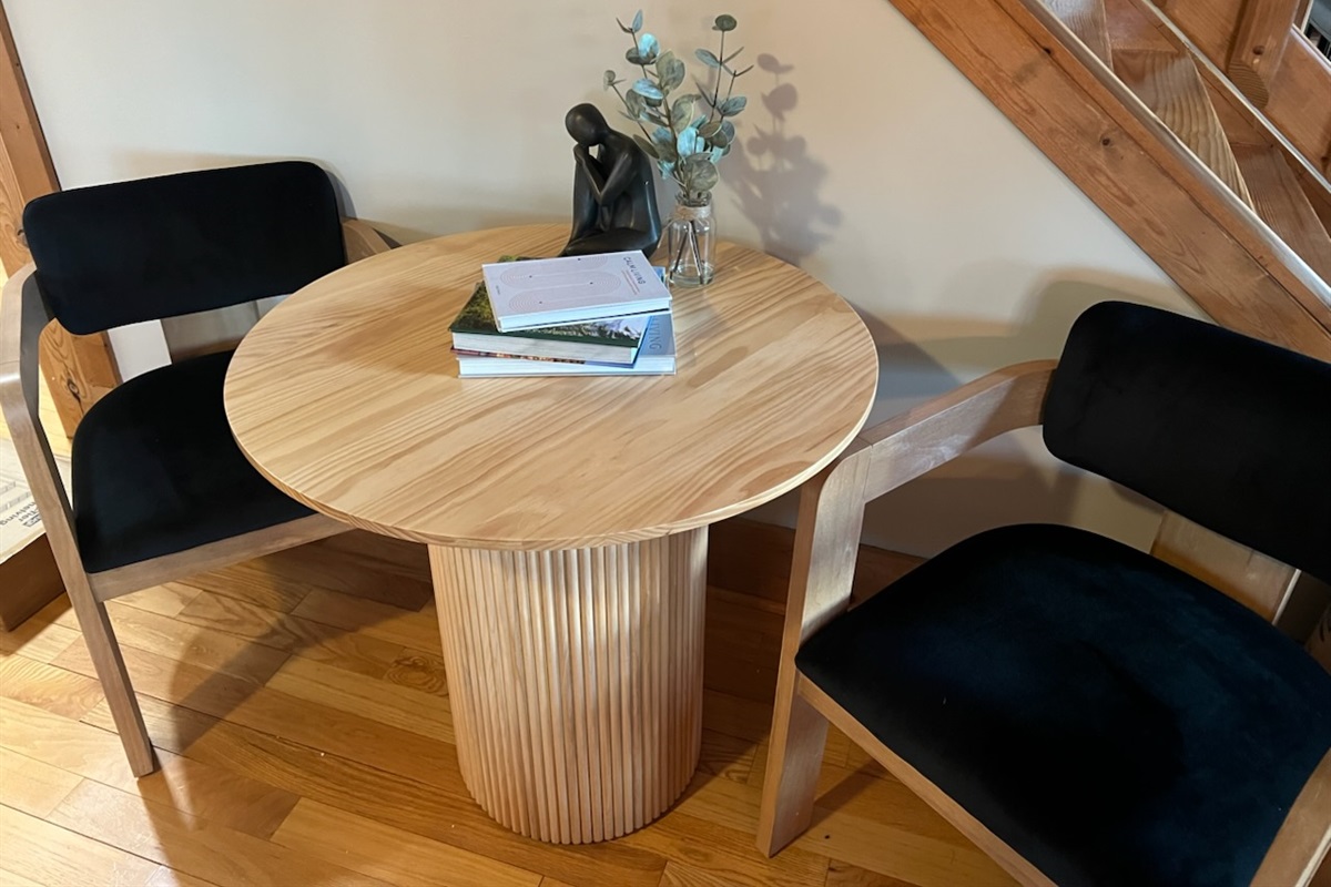 This cozy corner table offers a peaceful spot for morning coffee, quiet conversation, or planning your next adventure in comfort and style.