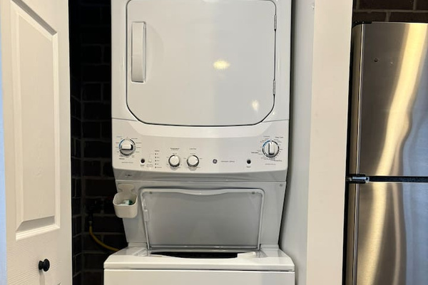 Washer and dryer are conveniently located beside the kitchen.