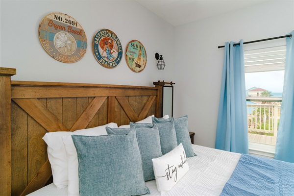 King Guest Suite — coastal neutrals, beach signs, curtains heavy enough to sleep past sunrise.
