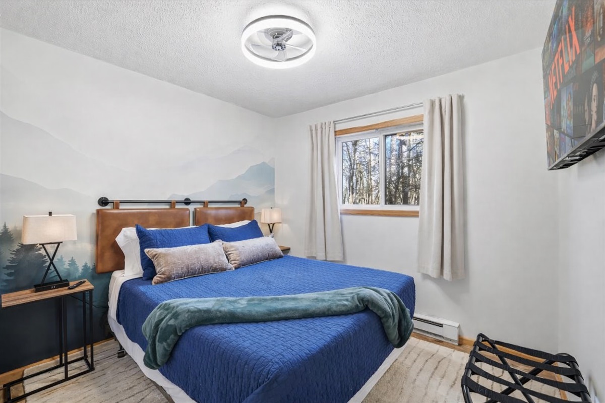 The downstairs bedroom offers comfort, warmth and the kind of restful sleep only a Poconos getaway delivers