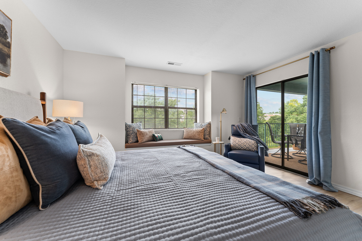A sliding door gives the primary bedroom direct access to the private covered balcony.