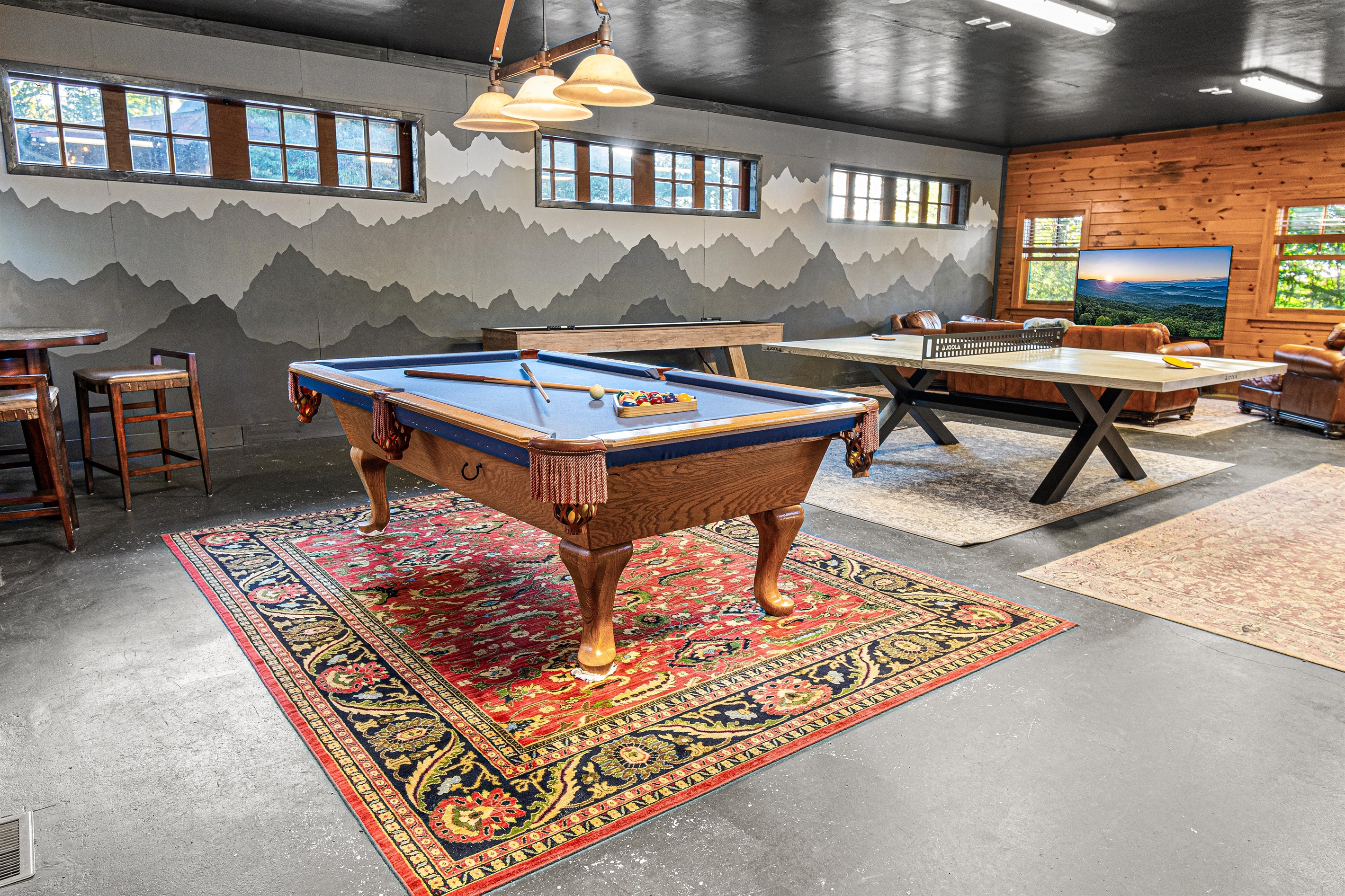 Large game Room located inside the garage with HVAC and bathroom, arcade games