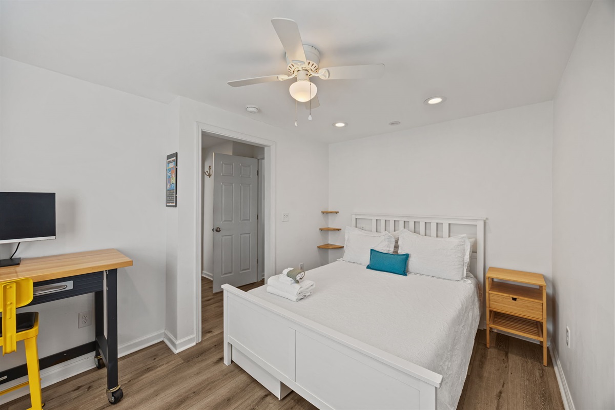 Comfortable queen bed with crisp linens and a simple, relaxing layout