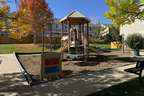 Explore endless fun at this spacious playground, featuring a charming little house with slides, a vibrant play area, and a comfortable sitting space for parents to relax while the kids enjoy their adventures.
