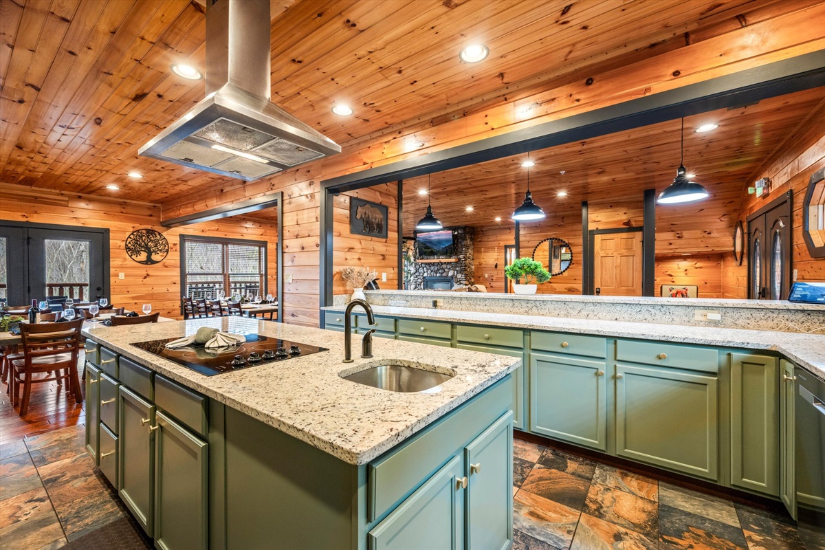 The large kitchen is well stocked and has an induction cooktop, two ovens, two sinks, two dishwashers, and two refrigerators.
