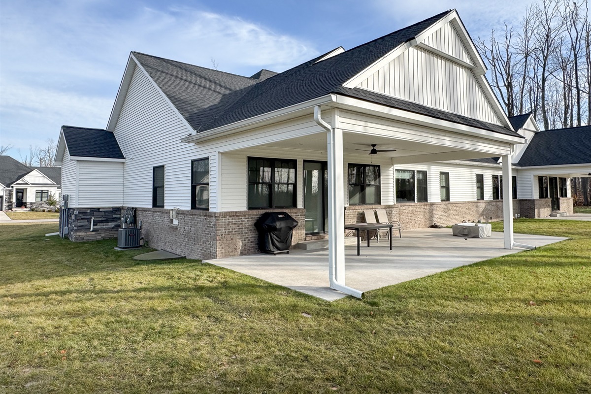 Patio area with gas fireplace, gas grill and comfortable seating in the summertime.