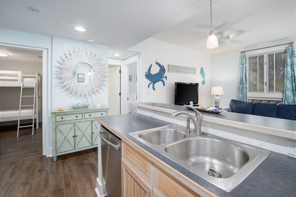 Kitchen sink and dishwasher at the breakfast bar, open to the living room and bunk bedroom
