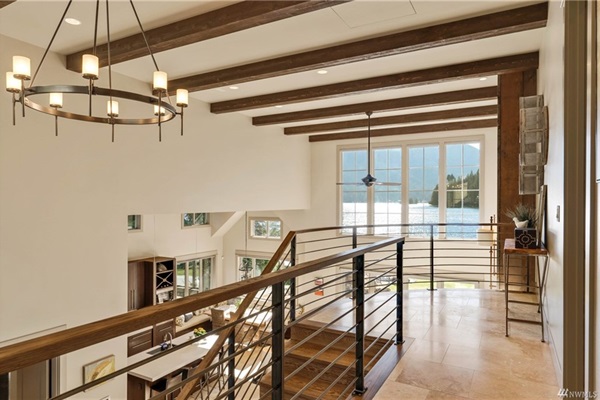 View from the upstairs landing, with open living spaces and panoramic lake vistas.