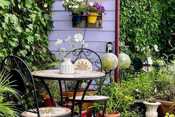 Secluded backyard with a bistro set, perfect for enjoying coffee, wine, or a meal outdoors.