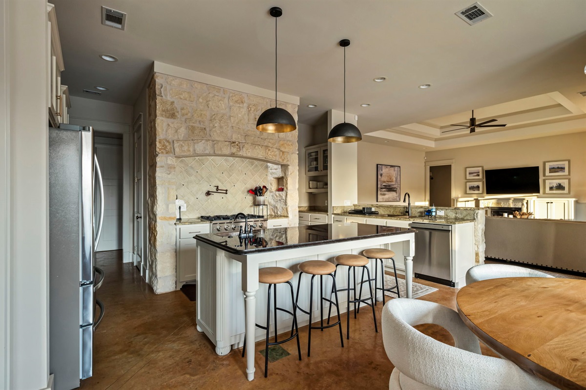 A fully equipped kitchenette includes a fridge, stove, oven, microwave, sink, and utensils for convenient cooking.
