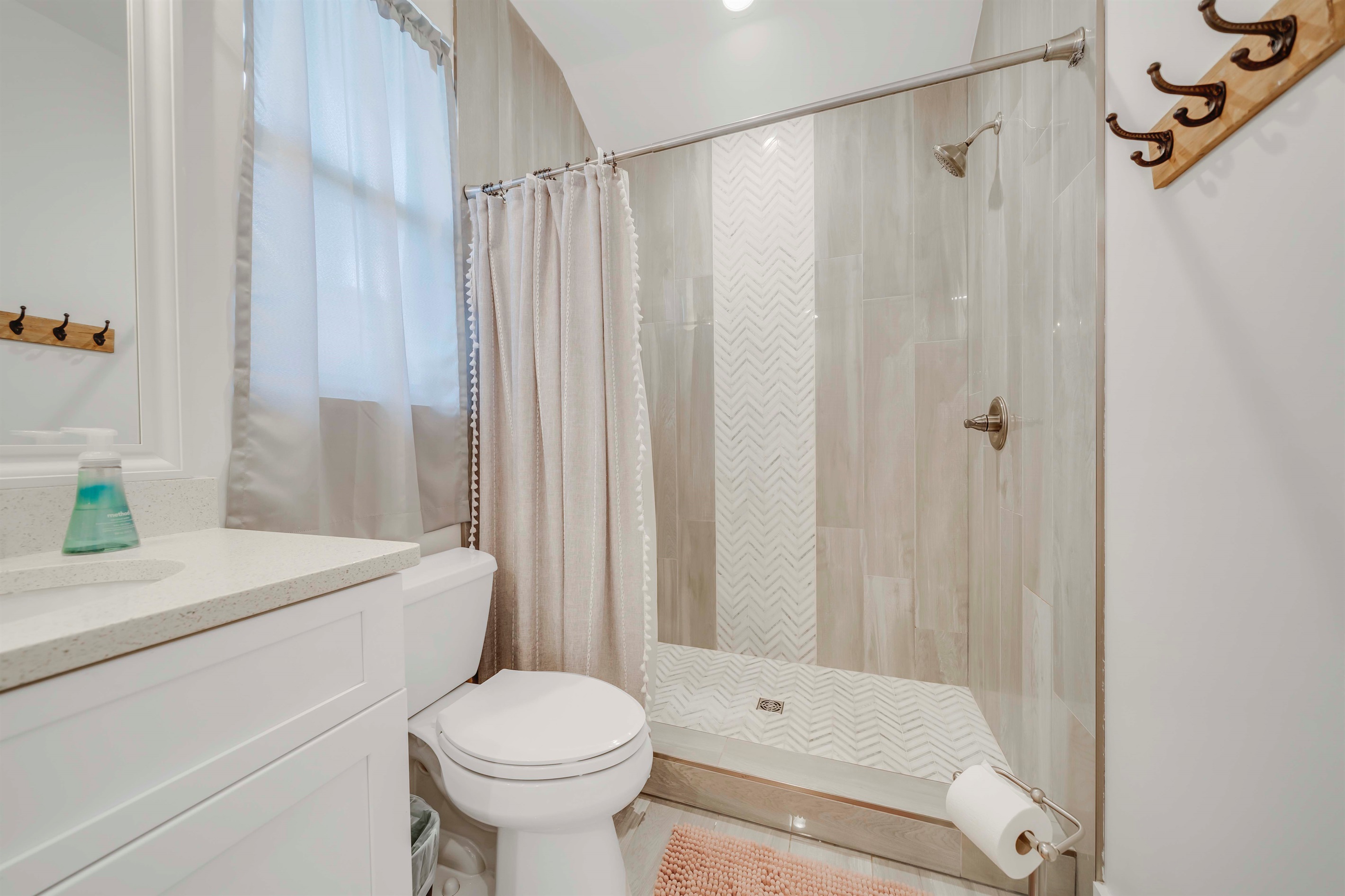 Start your morning in this bright primary master bathroom. Dual sinks and shower give two people plenty of room to get ready.