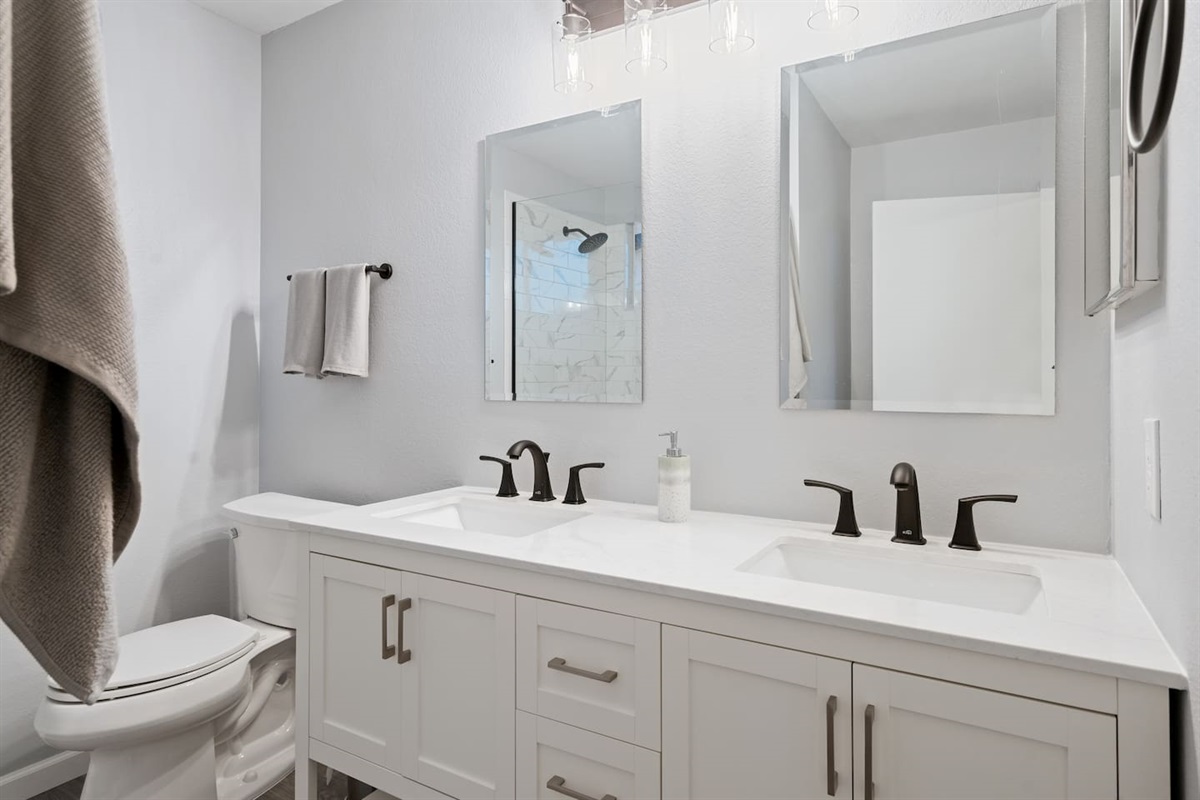 The primary bathroom has two sinks and nice, remodeled finishings.