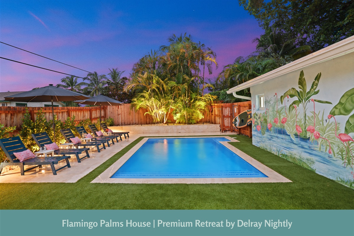Relax in your own tropical oasis at this luxury Delray Beach vacation rental, featuring a sparkling private pool, lush palm-lined surroundings, and designer outdoor lounge seating.