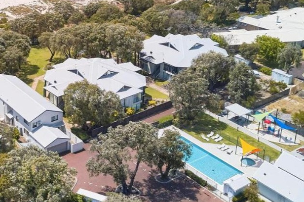 Birds eye view of pool area & playground within the complex