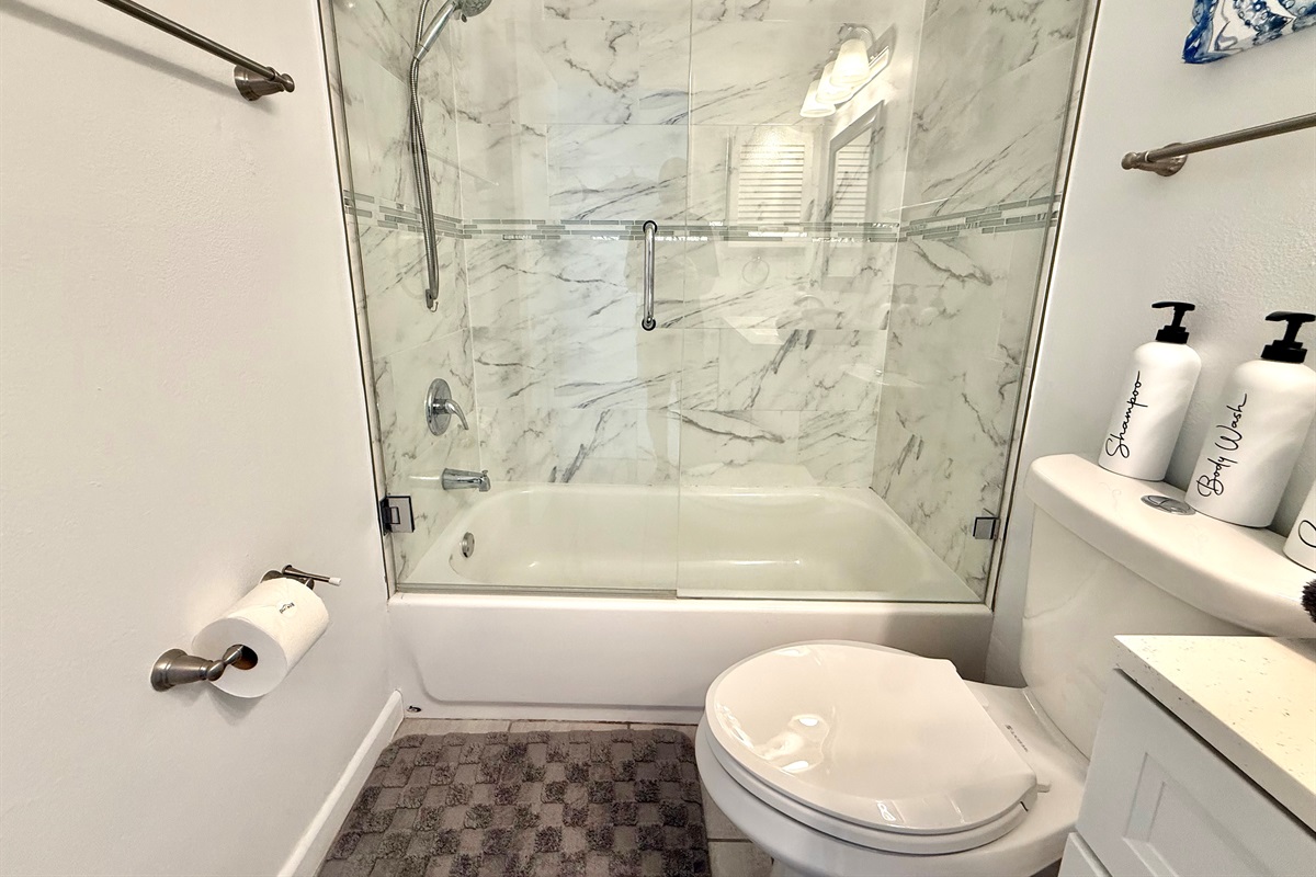 Perfect for soaking or a quick shower — this bathroom combines style with functionality.