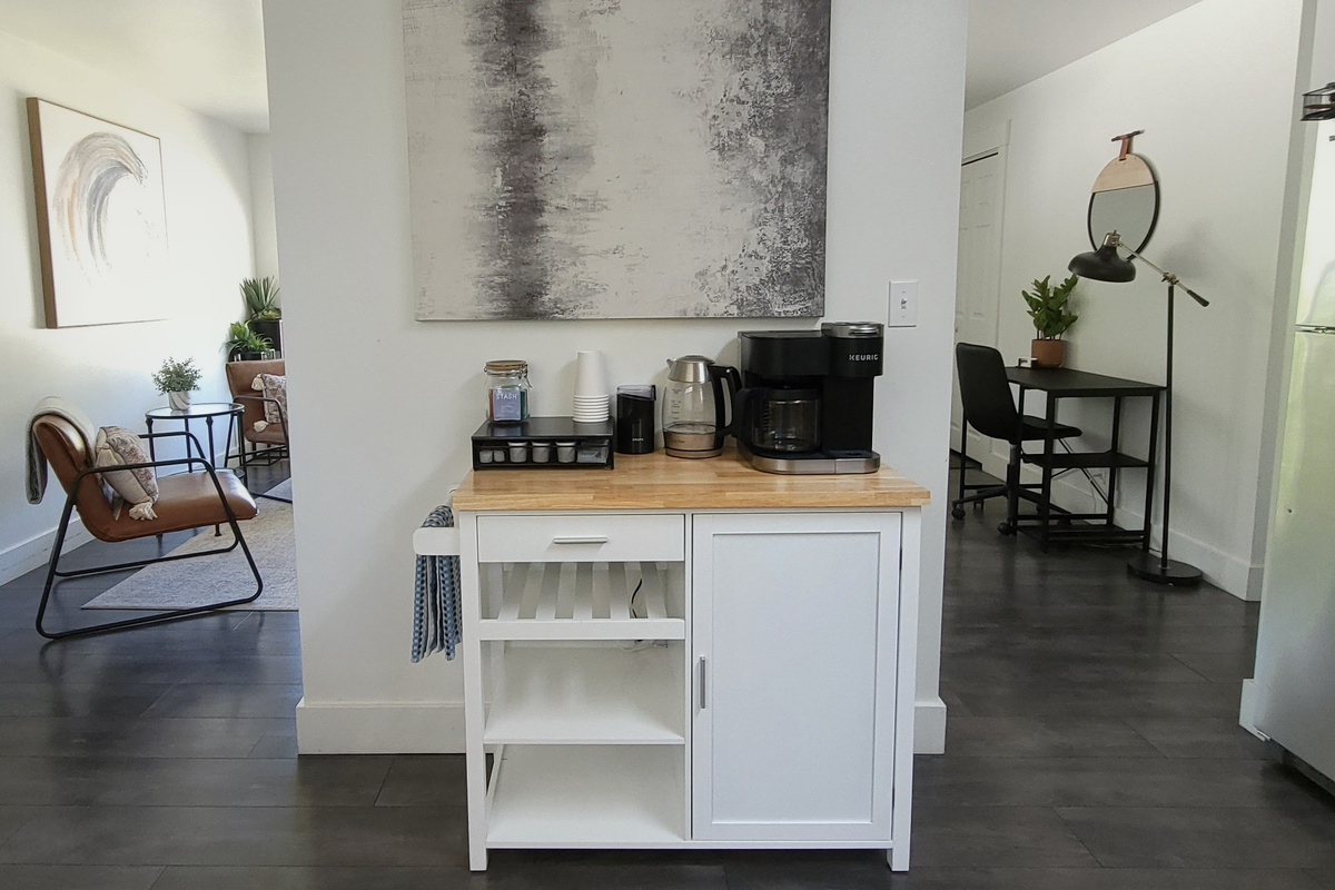 Coffee, tea, electric kettle, and coffee grinder. Extra storage for food in kitchen. 