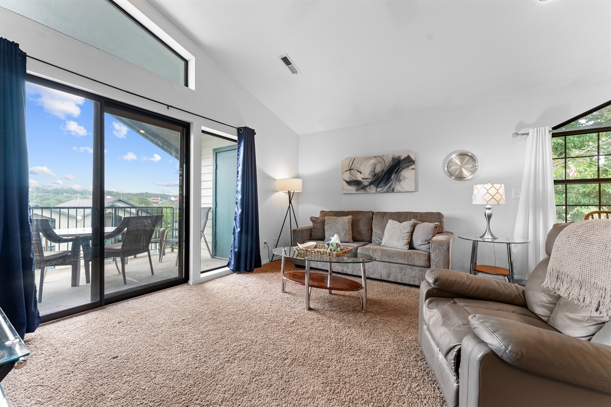 Another view of the living room, where the large sliders and vaulted ceiling keep the space feeling open.