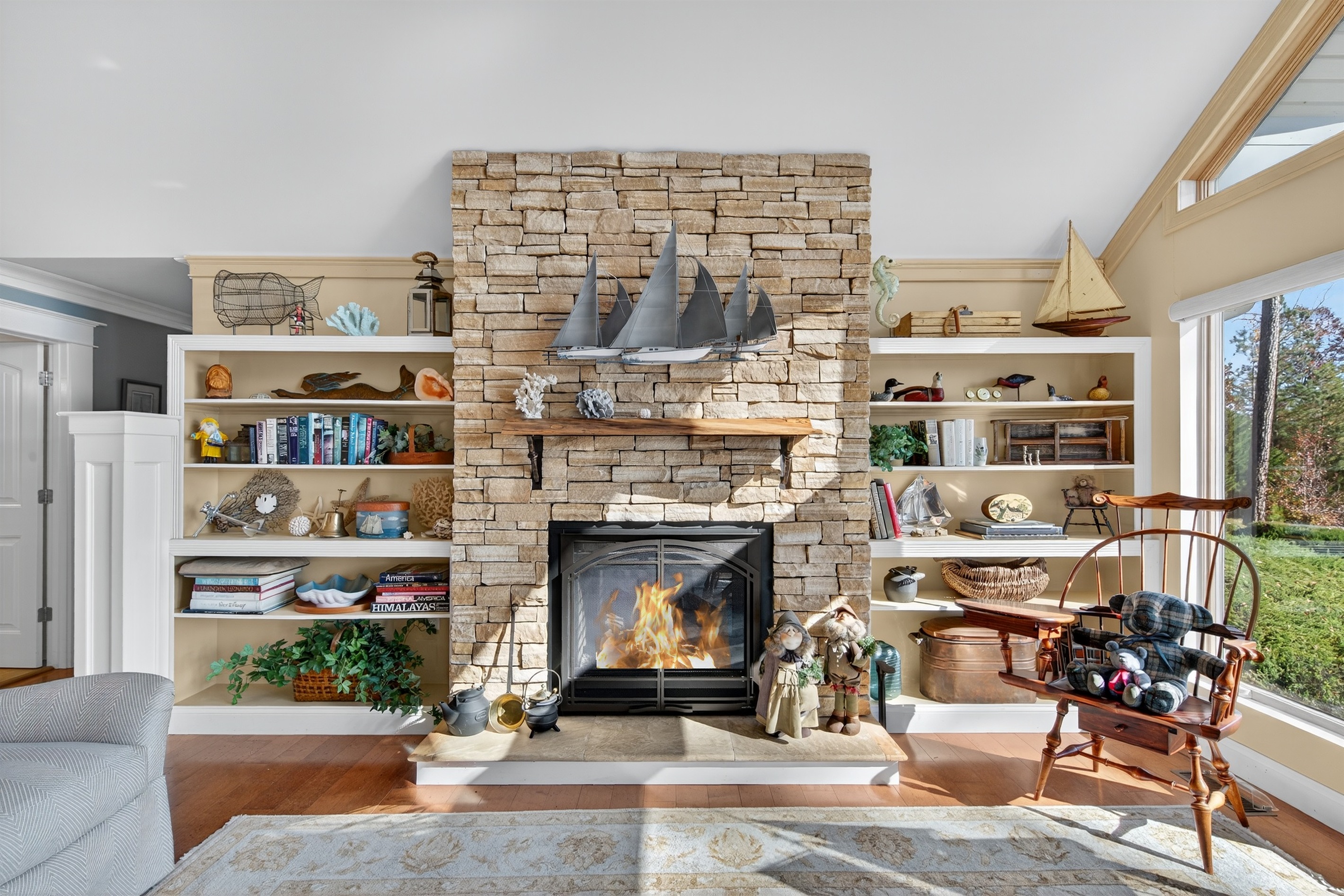 Charming stone fireplace surrounded by beautifully curated built-ins—perfect for relaxing nights in.