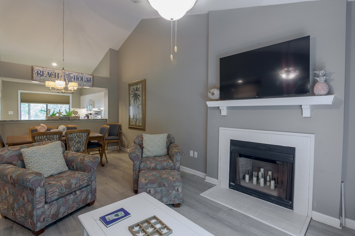 Comfortable living room with large TV and deck access