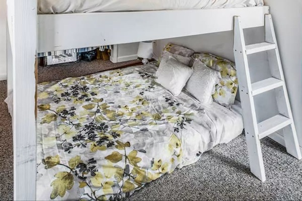 This bedroom is on the first floor of this Bi-level home. This offers a bunk queen bed with option of a loft with a twin bed (made for a child over 8 years old) or at your discretion.