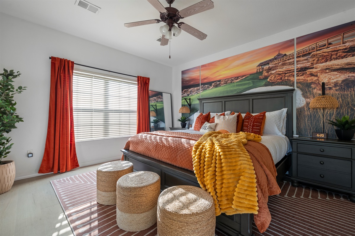The primary bedroom with Top of the Rock theme, king mattress, luxury linens, large smart TV and attached ensuite bathroom