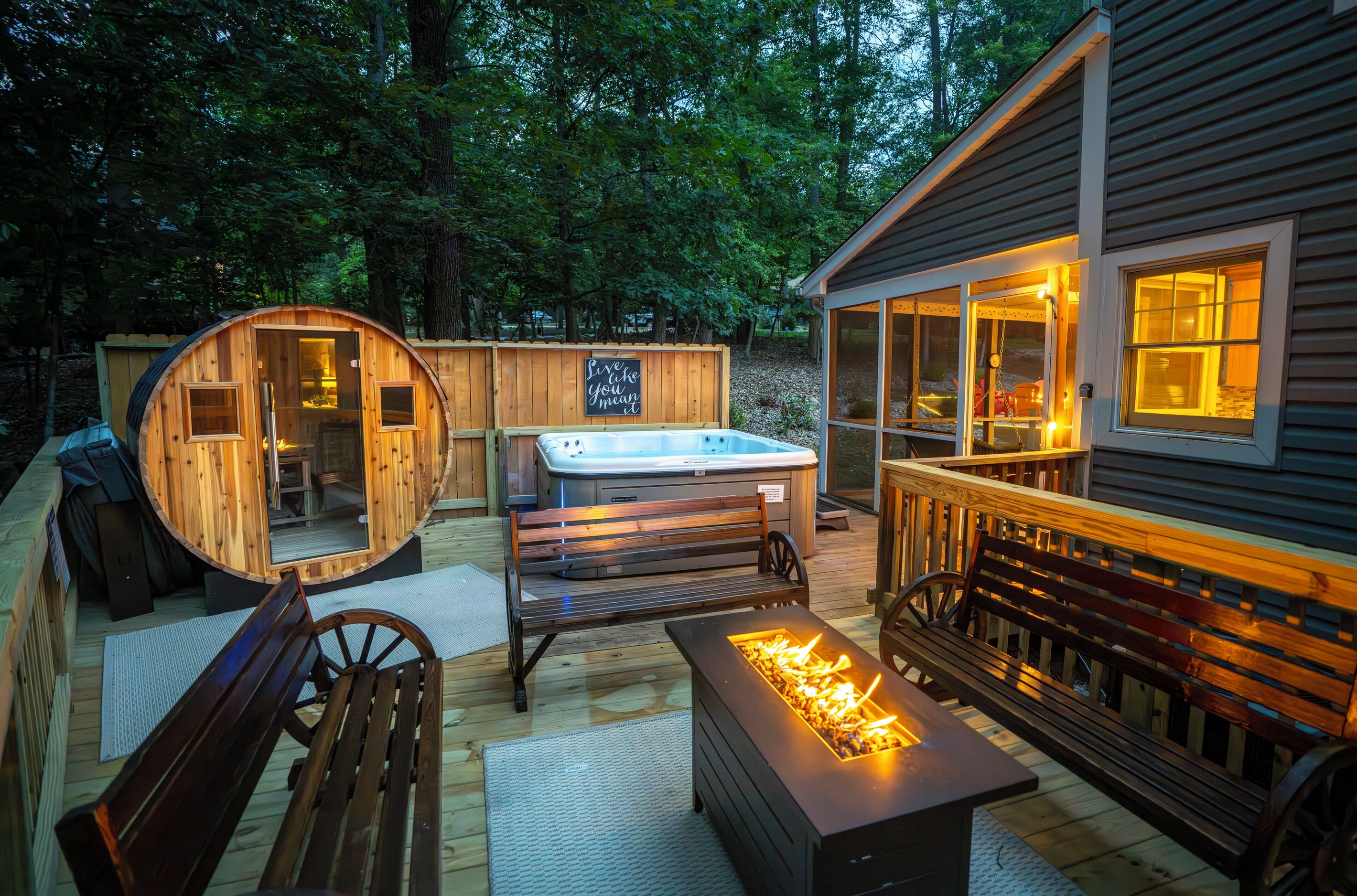 Deck with hot tub, sauna, and propane firetable / seating area
