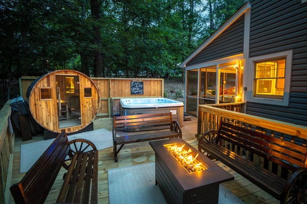 Deck with hot tub, sauna, and propane firetable / seating area
