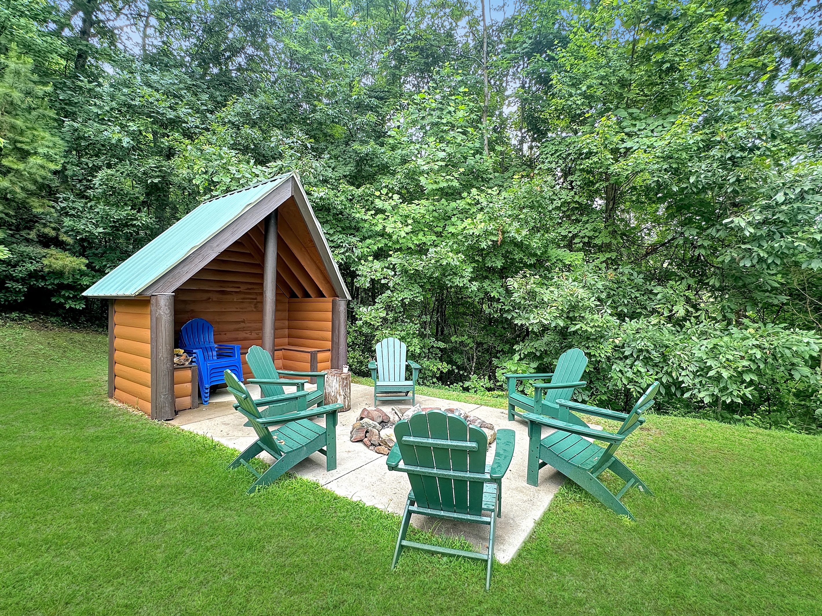 Outdoor: Gather around the fire pit in vibrant chairs, surrounded by nature's beauty!