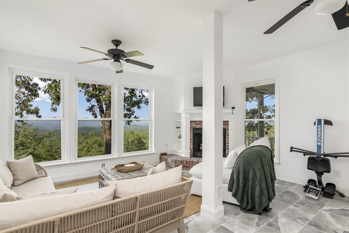 Secondary living room in upstairs w/ fireplace and smart TV-- wall of windows w/ gorgeous views